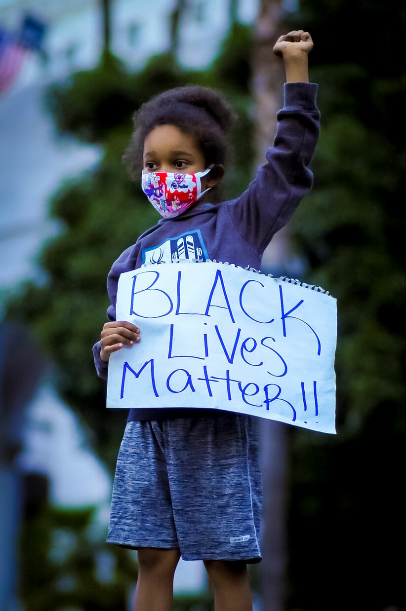 Child with black lives matter sign